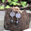 silver dangly earrings with pearl on bark background