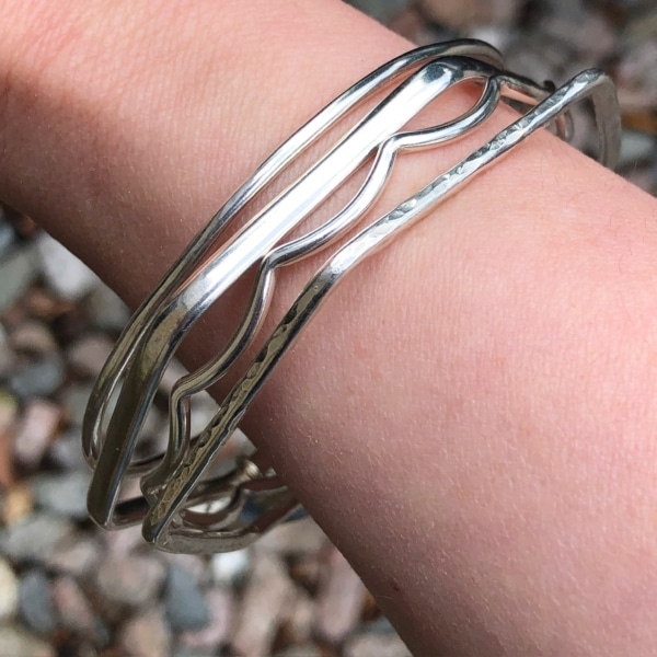 Silver bangles being worn