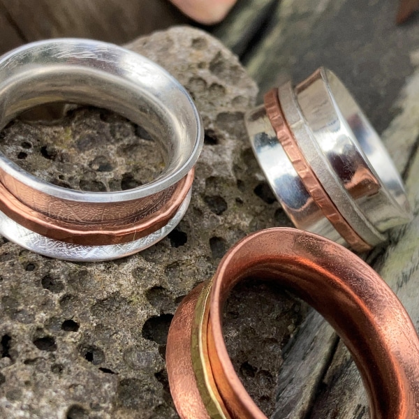 Silver and copper spinner rings with copper and brass spinners