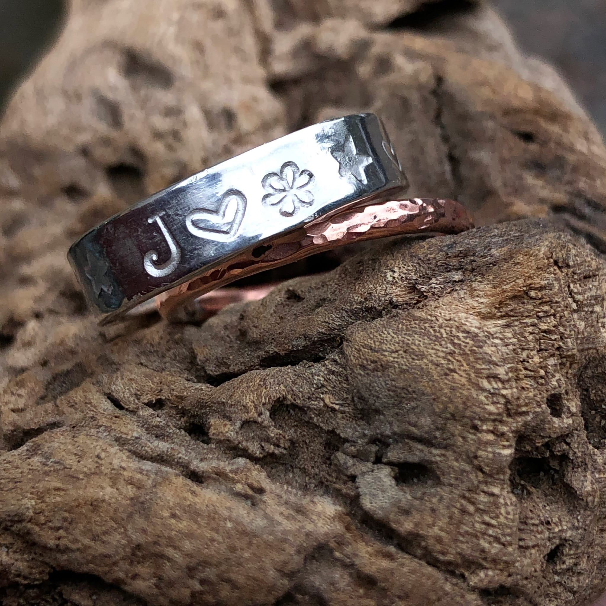 Silver ring with stamped details and hammered copper ring