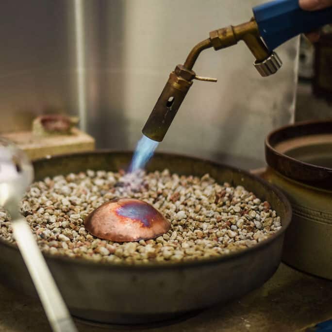 Copper bowl being annealed with gas torch