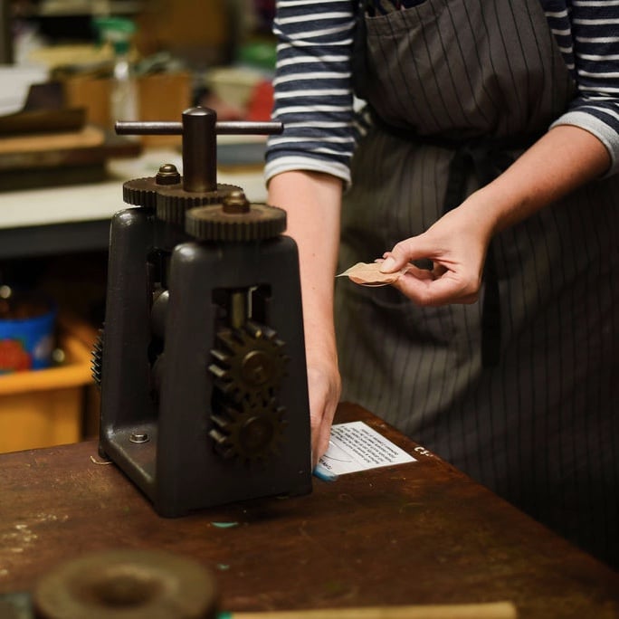 putting metal and skeleton leaf through the rolling mill to texture