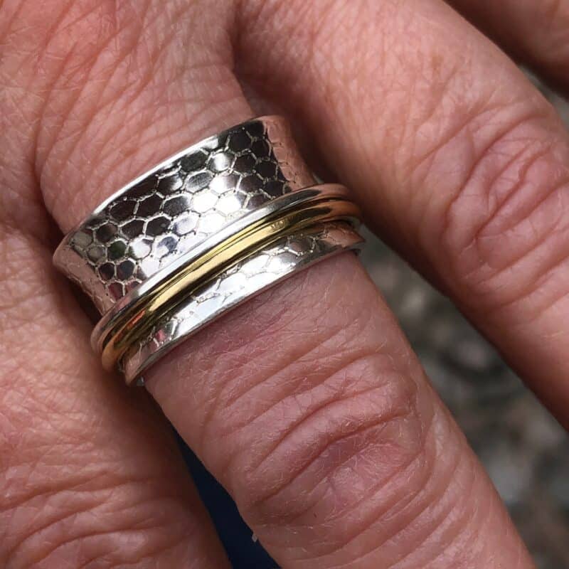 Silver spinner ring with honeycomb texture and brass and silver spinners