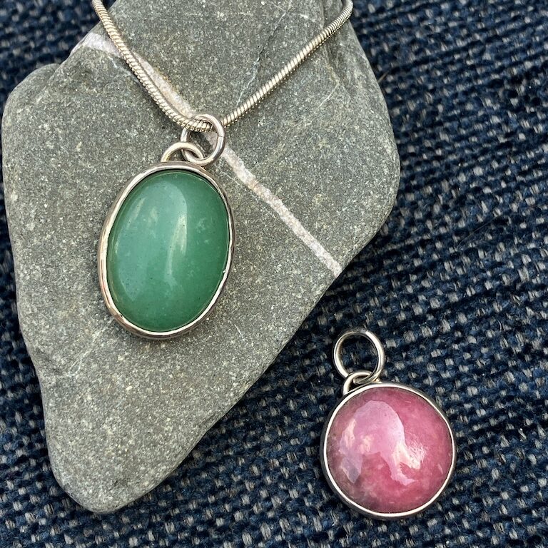 Bezel set pendants with green and pink stones