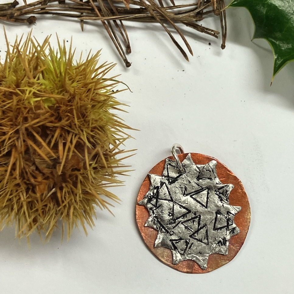 Mixed metal decoration with spiky foliage