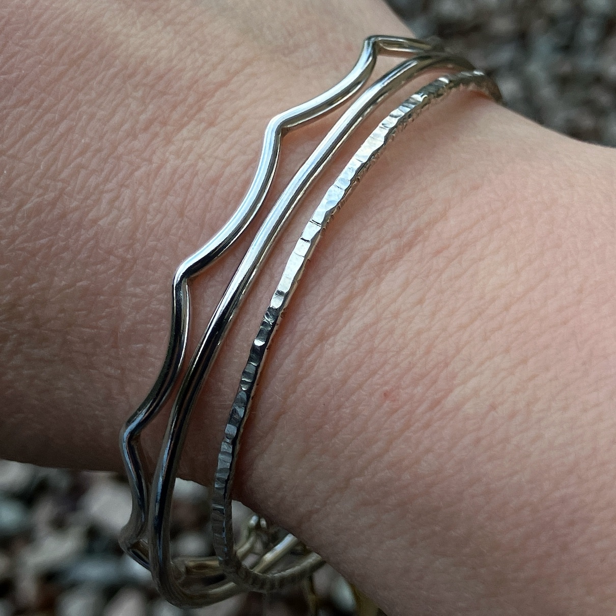Silver bangles being worn