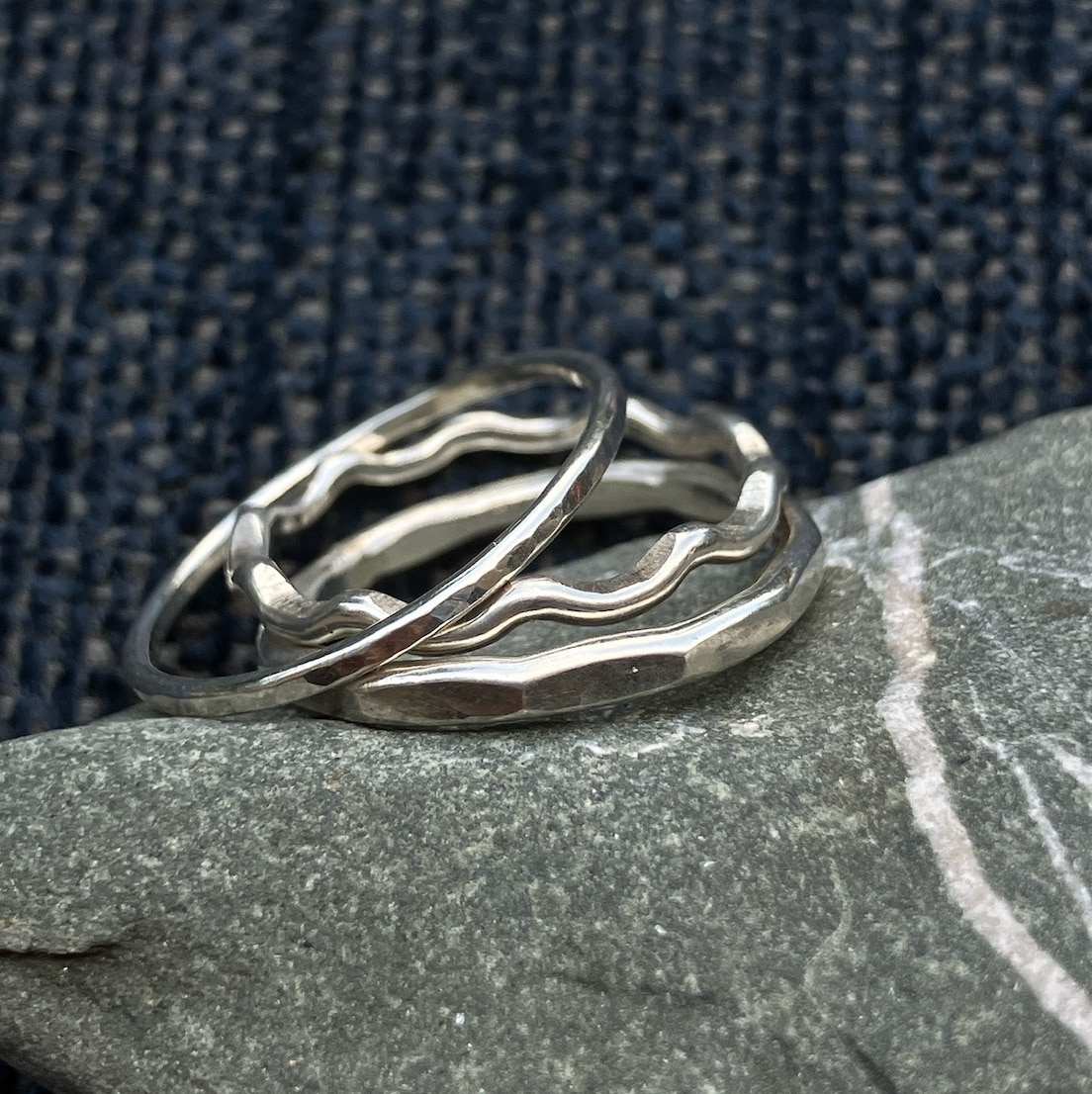 Silver stacking rings on a stone