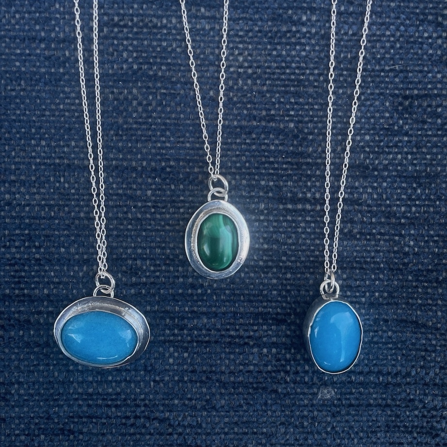 Stone set pendants with blue and green stones