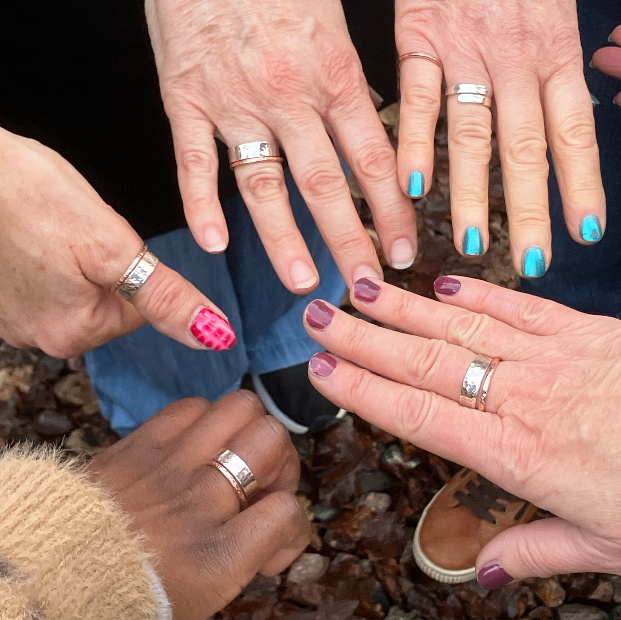 Silver rings being worn by the hands that made them