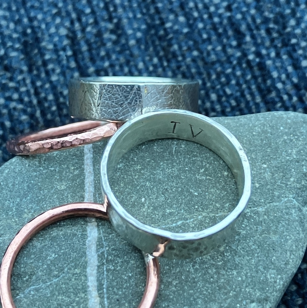 Silver and copper rings on a stone