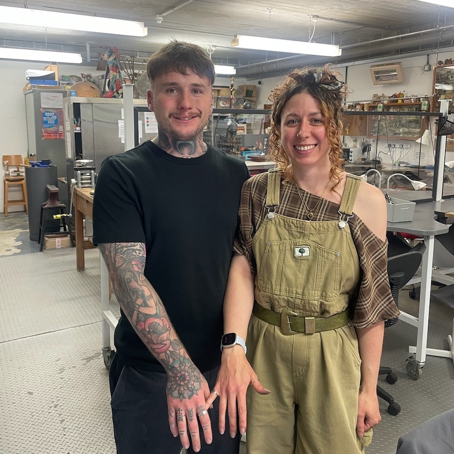 Happy couple making silver rings together