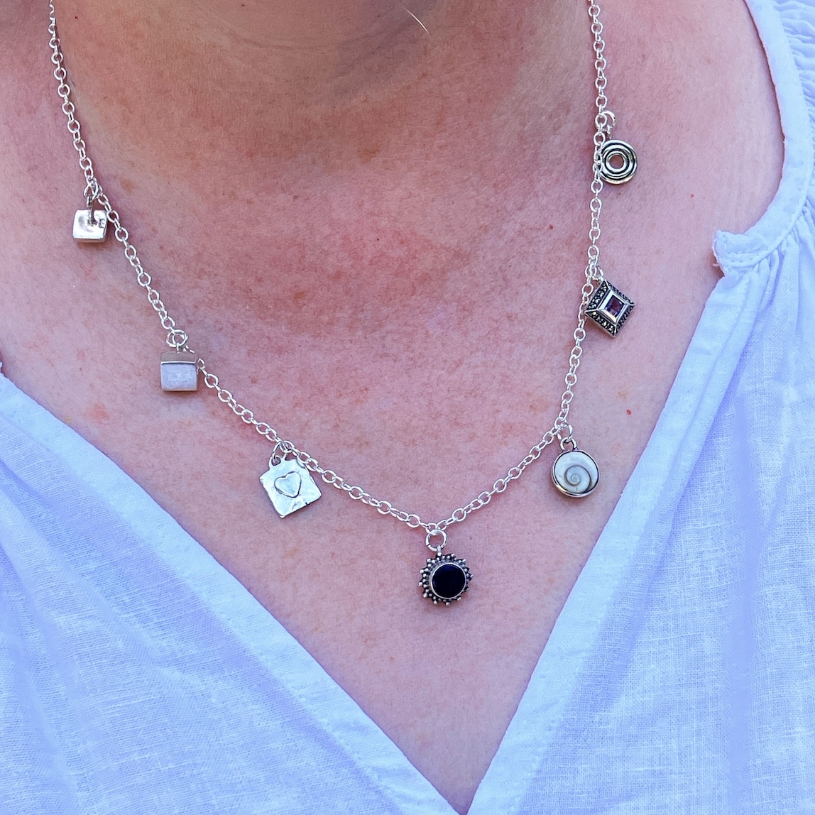 Charm necklace made from odd and broken silver earrings