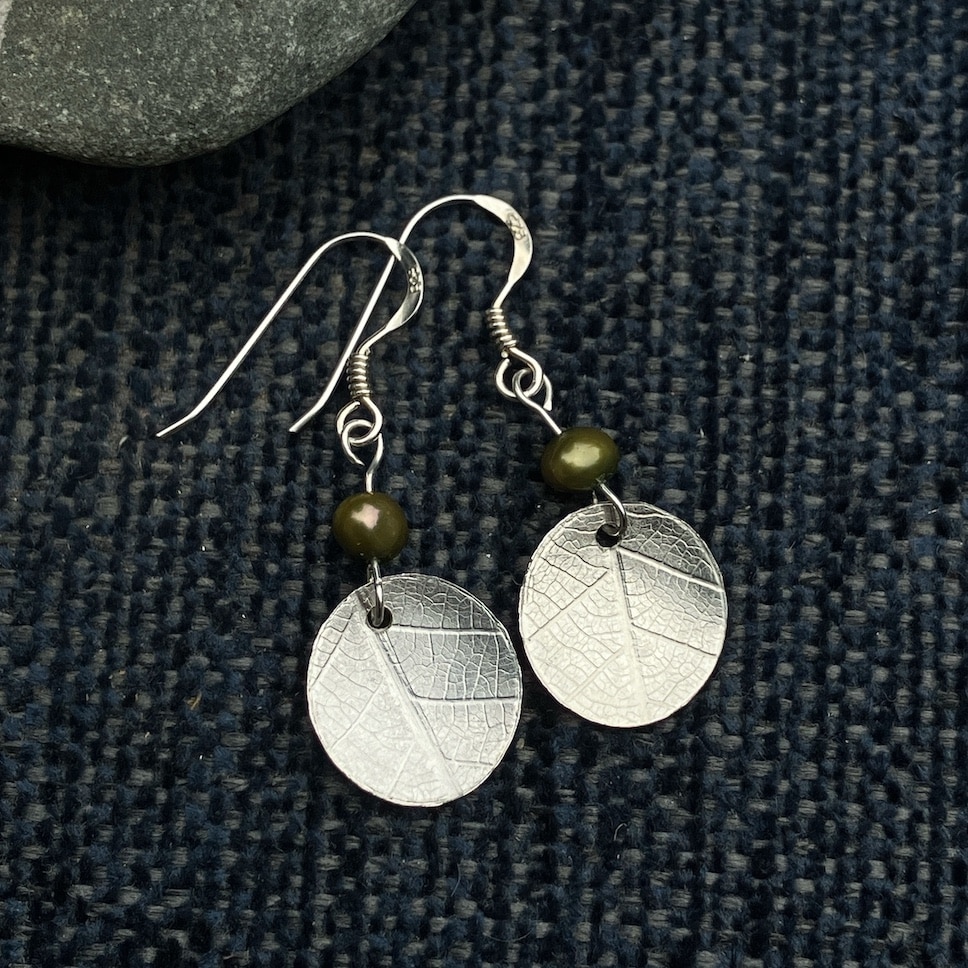Silver earrings with leaf print and green bead