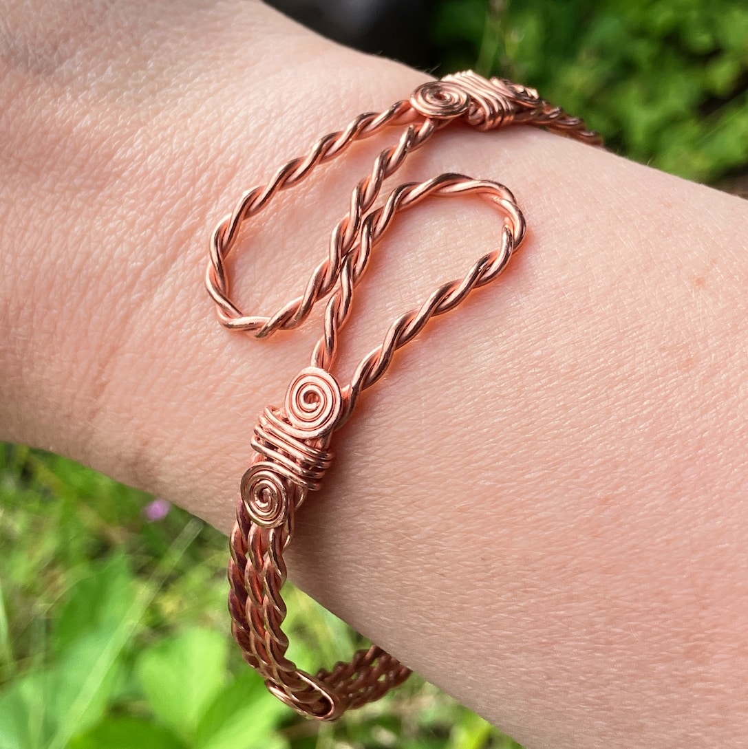 Copper Celtic bangle being worn.